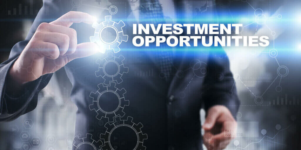 Businessman selecting investment opportunities on virtual screen.