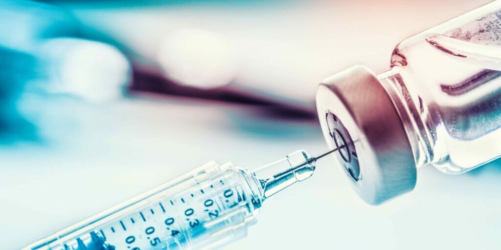 Close-up medical syringe with a vaccine.