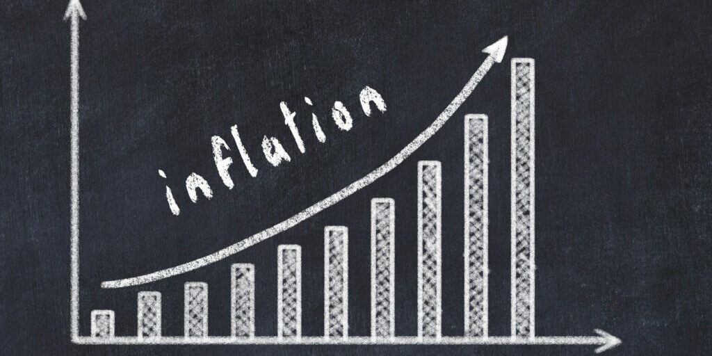 Chalkboard drawing of increasing business graph with up arrow and inscription inflation.